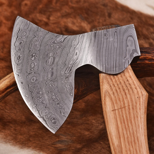 Decorative axe with a wooden handle on a brown background