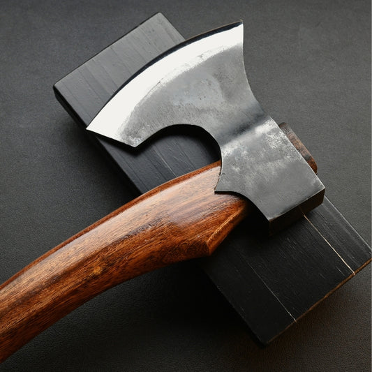 Wooden-handled axe on a dark gray background