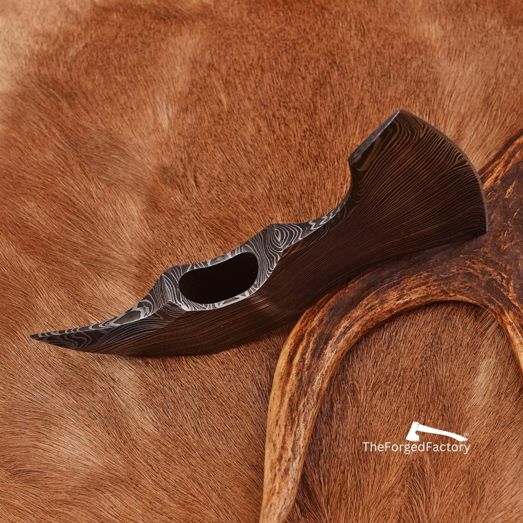 Decorative wooden tool on a brown fur background with 'The Forged Factory' branding.