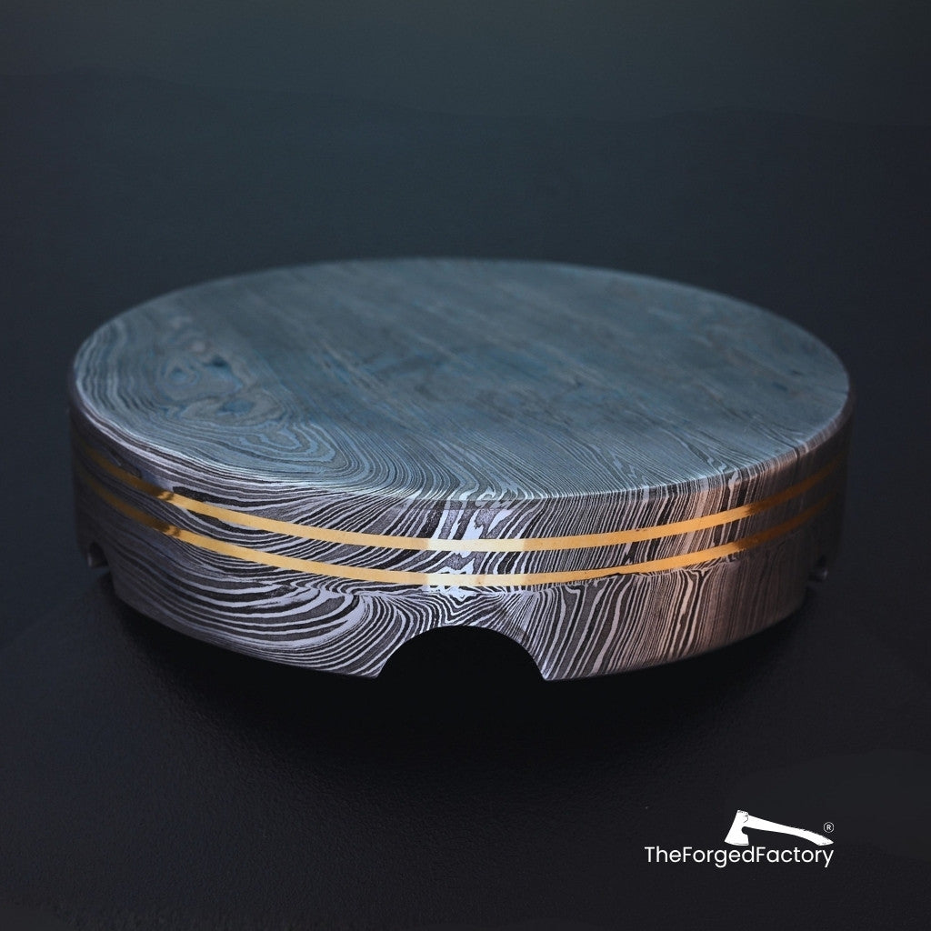 Round wooden cutting board with a marble-like pattern on a dark background, branded 'The Forged Factory'.