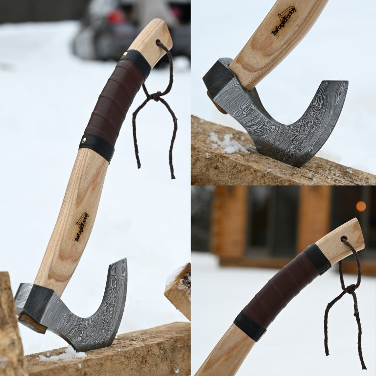 Wooden-handled axe with a metal head and leather sheath on a snowy background