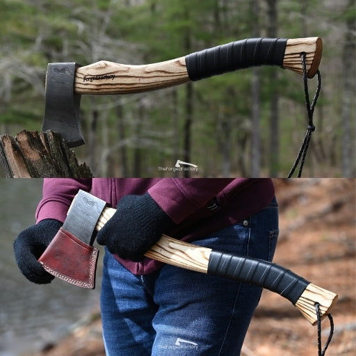 hand forged wooden axe with leather grip on handle and leather sheath on head, held by a person in a forest setting