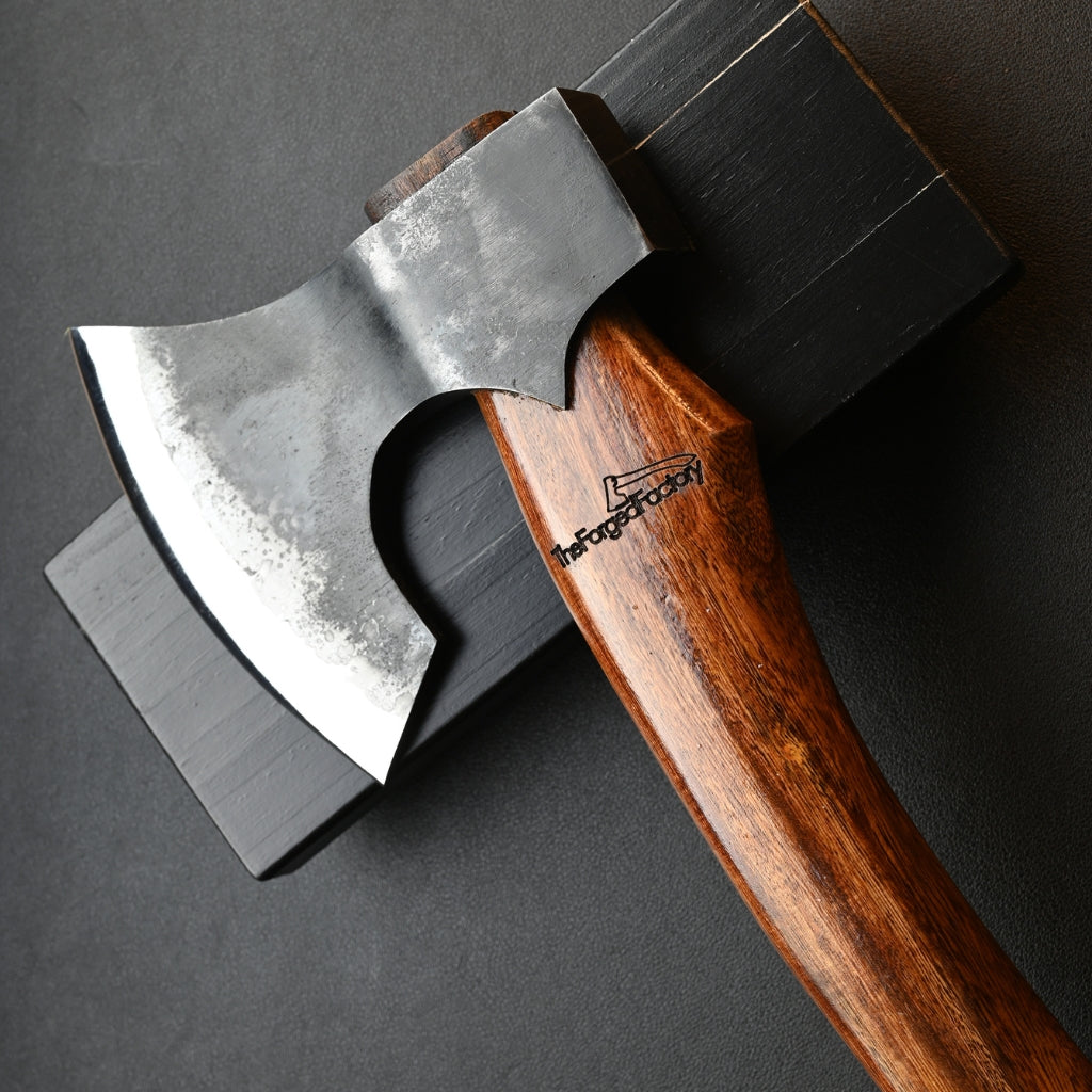 Wooden-handled axe with metal head on a dark background