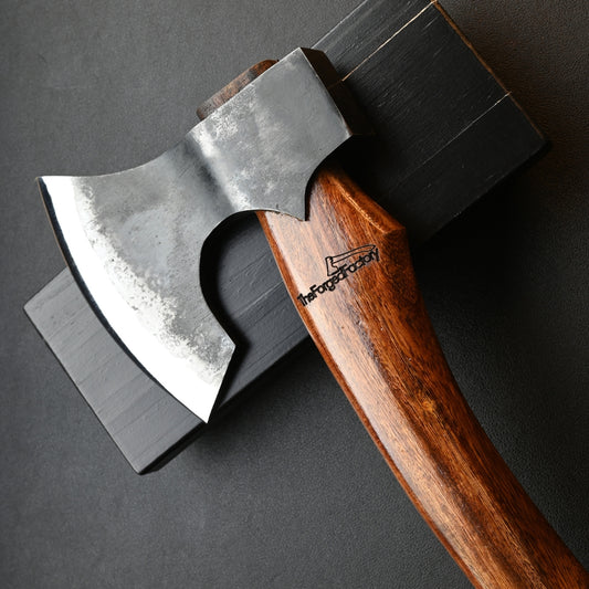 Wooden-handled axe with metal head on a dark background
