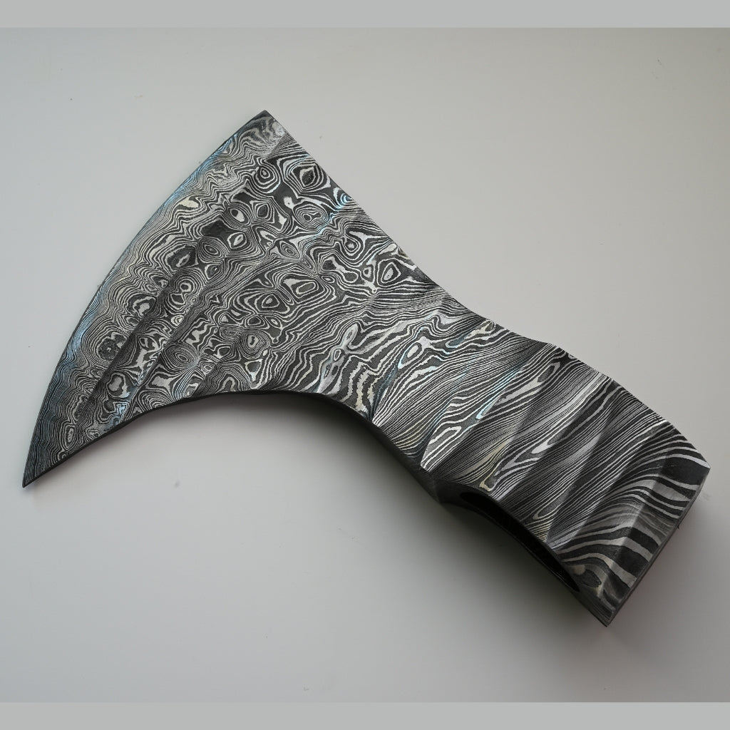 Decorative axe head with a unique pattern on a light gray background