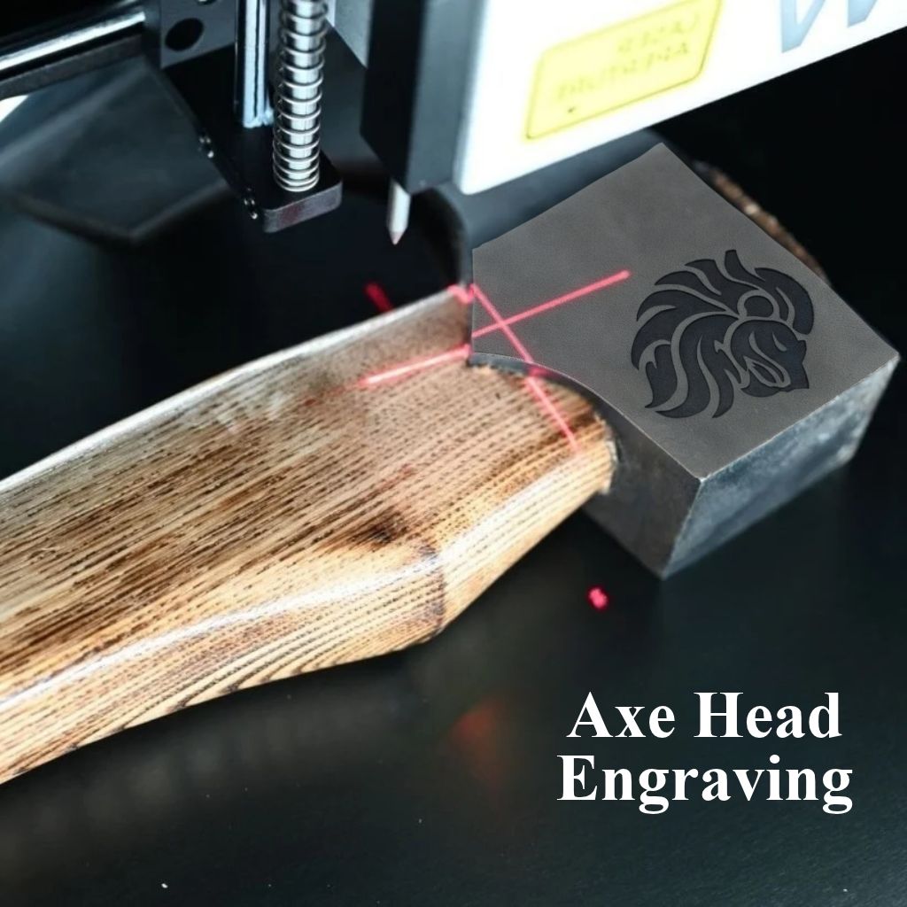 Steel axe Head being engraved with 'Lion Face' using a laser engraving machine.