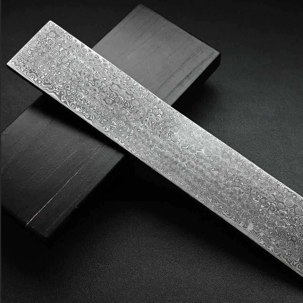 Decorative metal strip with intricate patterns on a dark background