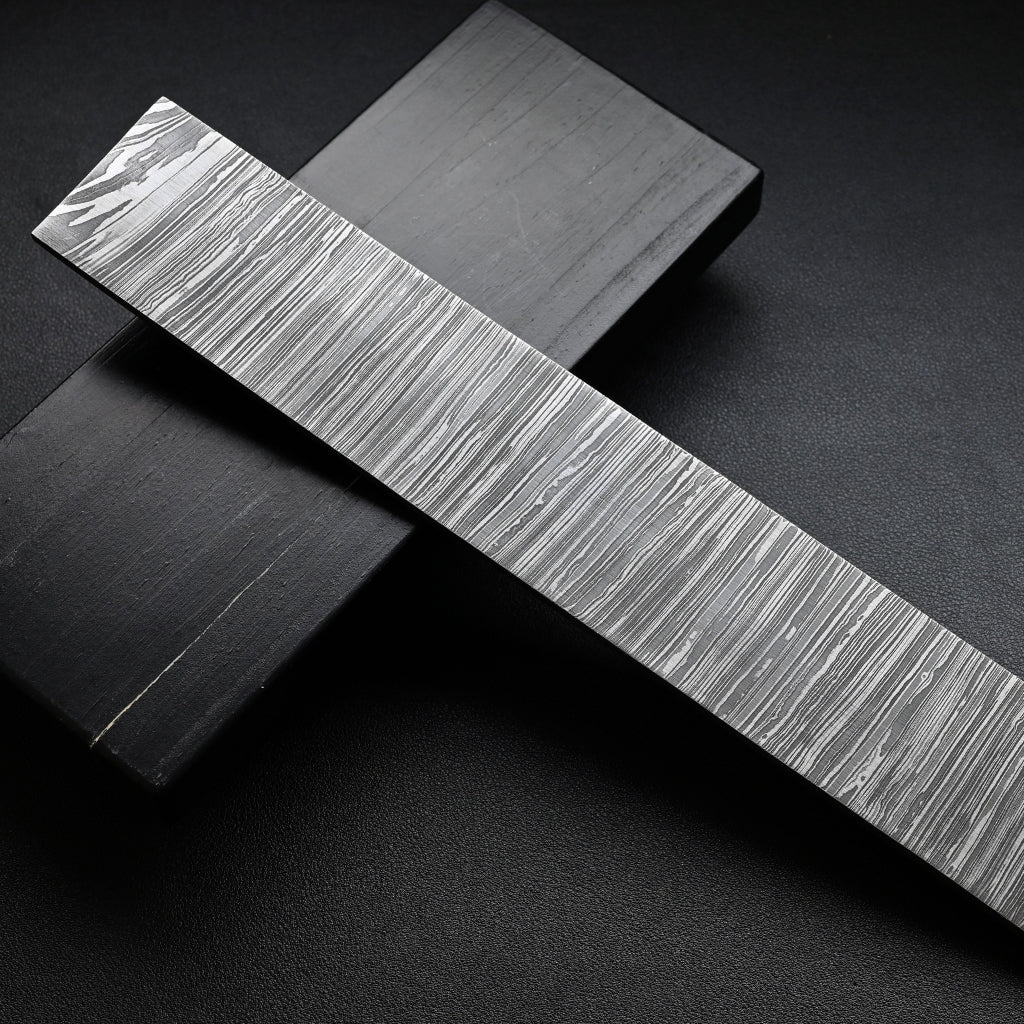 Metallic strip with textured surface on a dark background
