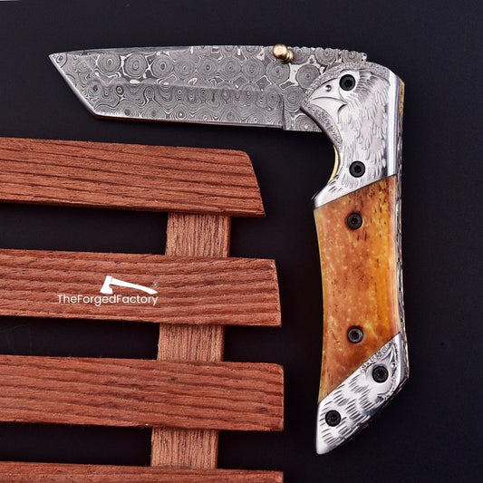 7.5-inch damascus steel folding pocket tanto knife with bone handle on black background