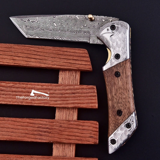7.5-inch damascus steel folding pocket tanto knife with walnut wood handle on black background