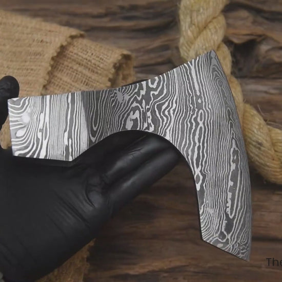 Multi-angle video of hand-forged Damascus axe head by “TheForgeFactory” for custom axe builds and bushcraft tools.