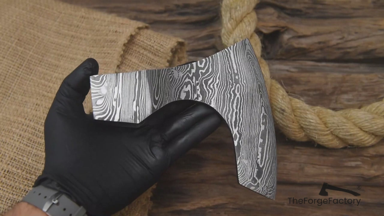 Multi-angle video of hand-forged Damascus axe head by “TheForgeFactory” for custom axe builds and bushcraft tools.