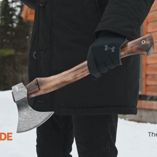 Multi-angle outdoor video of handmade axe with wooden handle, showcasing forged axe craftsmanship in a winter setting.