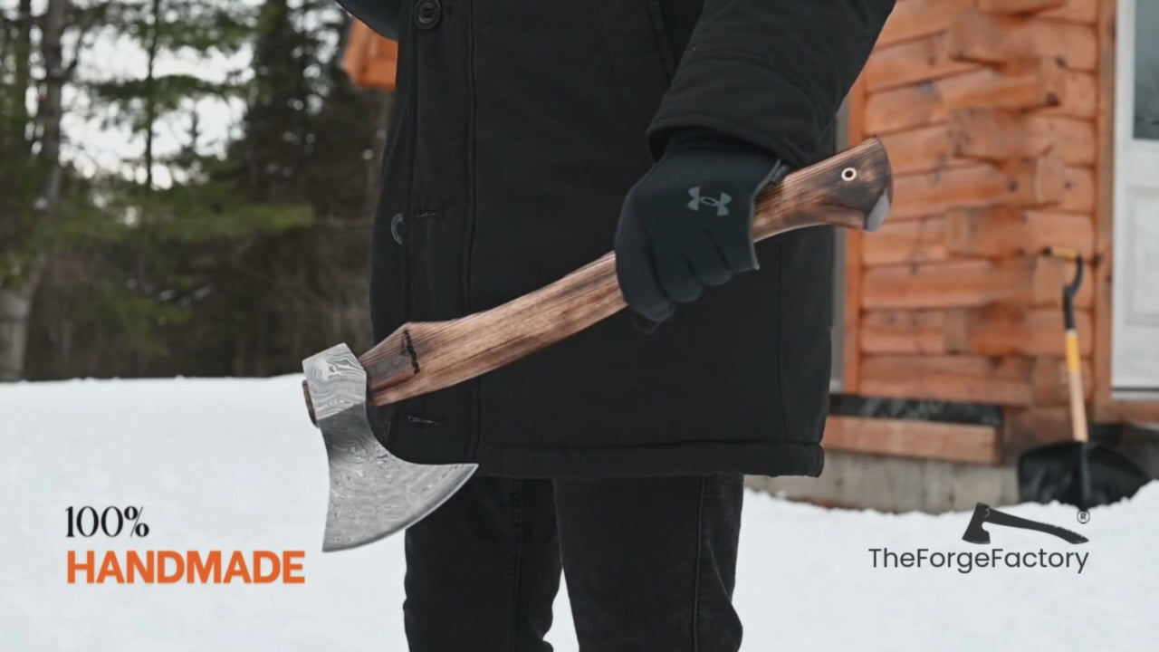 Multi-angle outdoor video of handmade axe with wooden handle, showcasing forged axe craftsmanship in a winter setting.