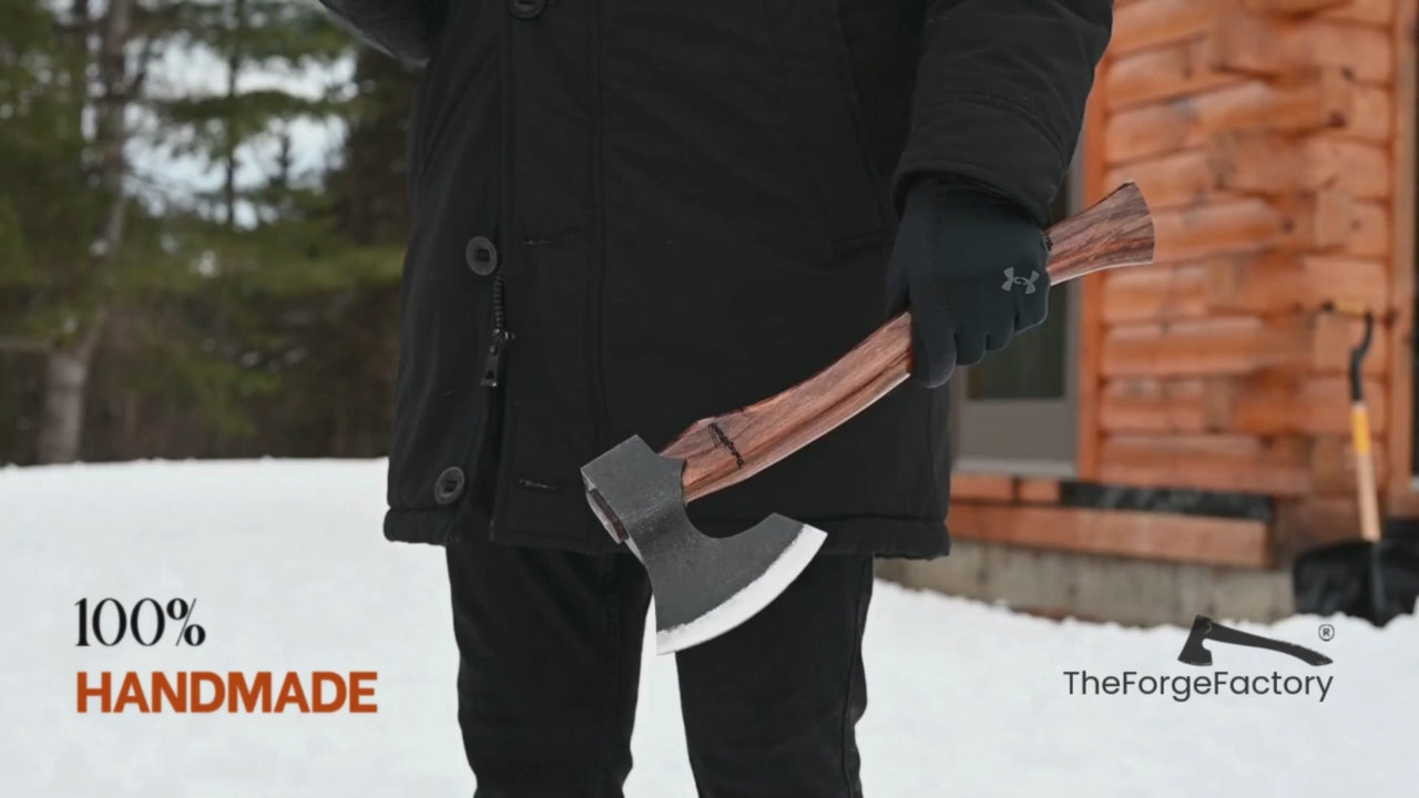 Multi-angle outdoor video of handmade carbon steel axe with wooden handle, showcasing forged bushcraft axe craftsmanship in a winter setting.