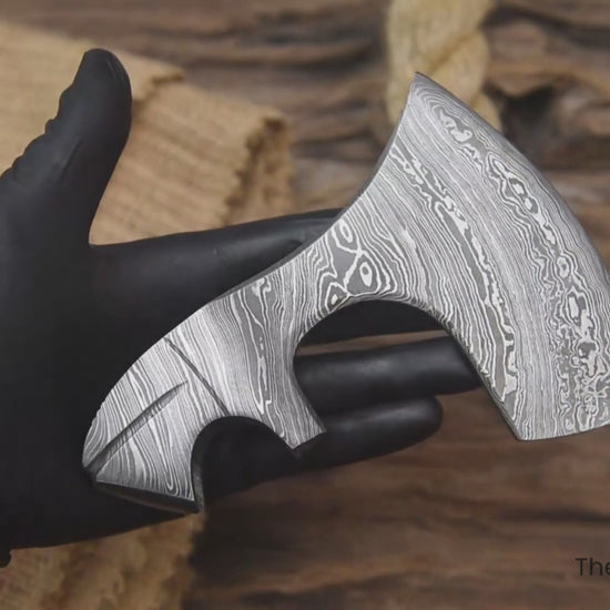 Rotating Damascus steel axe head video with “TheForgeFactory” branding for handmade camping and Bushcraft axes.