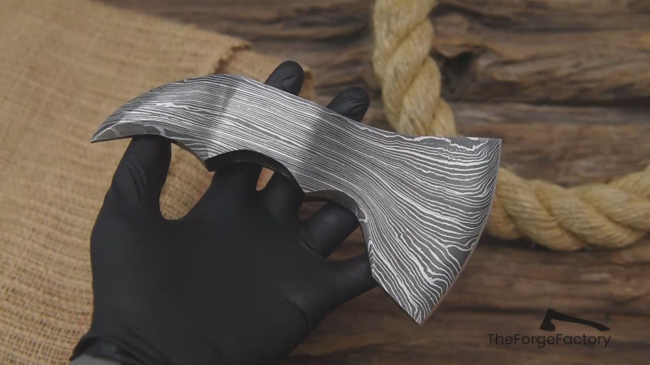 Close-up video of forged Damascus axe head designed for custom hatchet builds and outdoor craftsmanship projects.